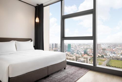 Postel nebo postele na pokoji v ubytování Citadines Flatiron Phnom Penh
