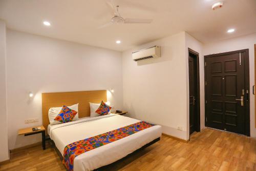 a bedroom with a large bed in a room at FabHotel A One Paschim Vihar in New Delhi
