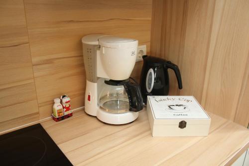 a coffee maker sitting on a counter next to a box at Apartments Gabl in Schönwies