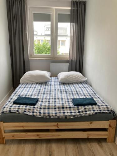Кровать или кровати в номере Beach Apartment Ergo Arena