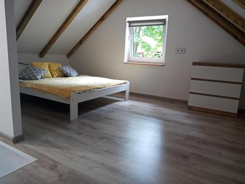 ein Schlafzimmer mit einem Bett im Dachgeschoss in der Unterkunft Ośrodek Wypoczynkowy Leśny Zakątek in Sieraków