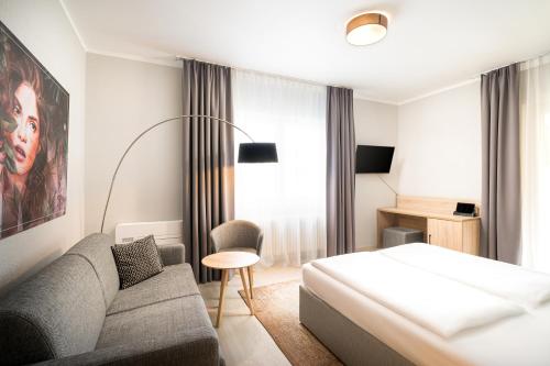 Una cama o camas en una habitación de Arthotel ANA Eden