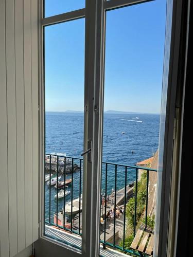 a room with a window looking out at the ocean at Casa a Mare in Sorrento