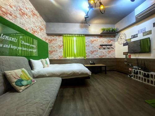 a living room with a couch and a tv in it at 一中街藻宿 in Taichung