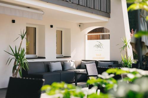 a living room with a couch and some plants at Hotel Fronza - your hike & mountain home in Lutago