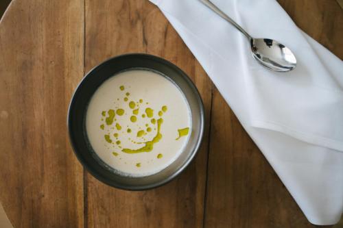 a bowl of milk next to a napkin and a spoon at Hotel Fronza - your hike & mountain home in Lutago