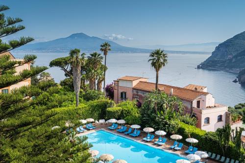 a resort with a swimming pool and a view of the water at Aequa Hotel in Vico Equense