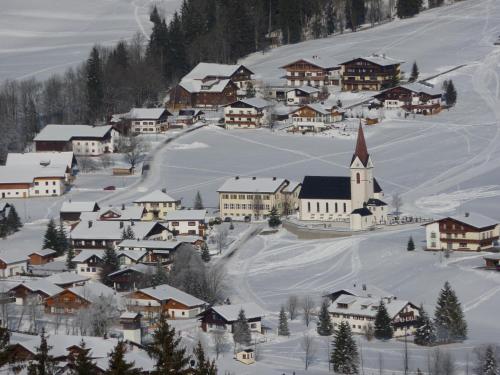 a small town covered in snow with a church at Ferienwohnungen Durst Roswitha in Schattwald