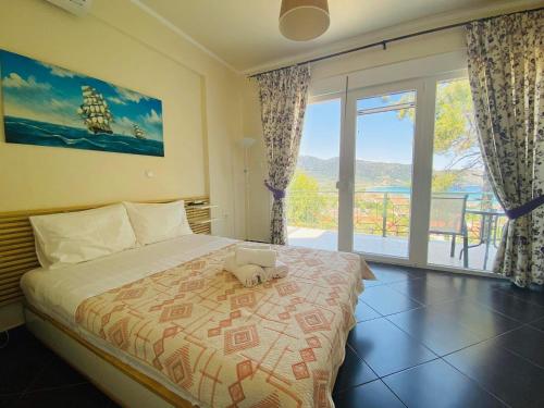 a bedroom with a bed and a large window at Villa Vision in Skala Potamias