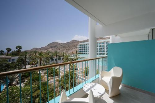 a balcony with chairs and a view of the mountains at Yam Suf by Isrotel Collection in Eilat