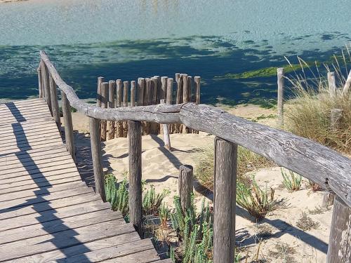 a wooden boardwalk on the beach near the water at Meerblick-Ferienhaus Casa Gino Apulien in San Pietro in Bevagna