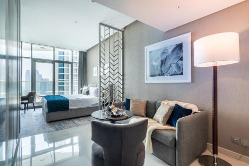 a living room with a couch and a bed at The Smart Concierge - Damac Maison Prive in Dubai