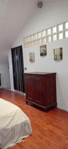 a bedroom with a bed and a wooden floor at Appartamento mansardato iPatrizi in Moncalieri