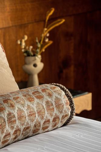 a close up of a couch with a vase of flowers at Relais Bernard Loiseau in Saulieu
