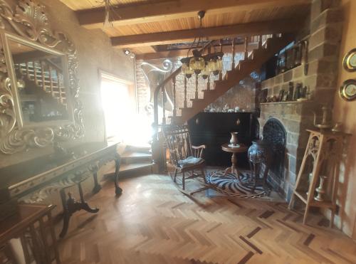 a living room with a staircase and a fireplace at Pas Birute in Kaunas