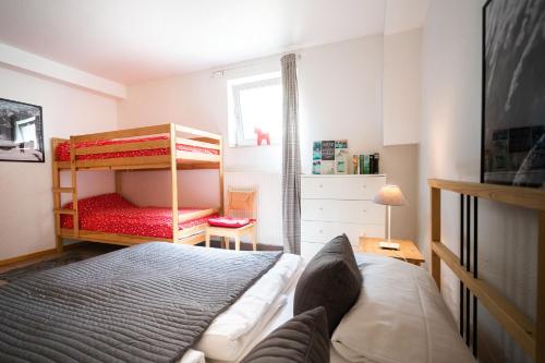 a bedroom with a bed and a bunk bed at Ferienhof Homann Sauerland in Brilon