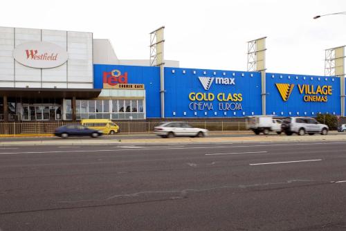 a city street with cars parked in front of a building at Best Western Plus Buckingham International in Moorabbin