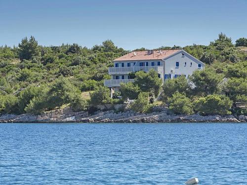 a large house on the shore of a body of water at Sunset Villa Hvar in Hvar
