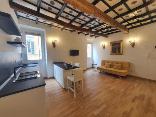 a kitchen and living room with a couch and a table at Charming Frattina - 2 bathrooms new apartment in Rome