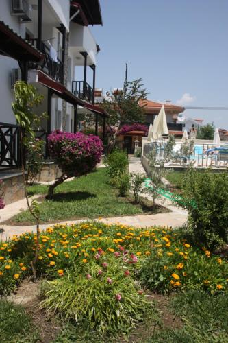 a garden with flowers in the middle of a building at Loya Vita Hotel in Dalyan