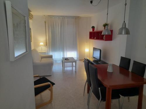Una sala de estar con una mesa y un comedor. en La Rambleta, en L'Ametlla de Mar
