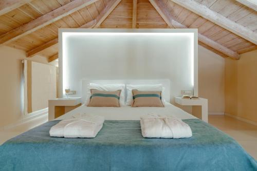 a bedroom with a large bed with two pillows at Chryssi Akti Family Villa and Studios in Argassi