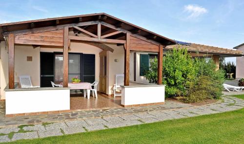 a pavilion with a table and chairs on a patio at Agriturismo Bocci in Castiglione della Pescaia