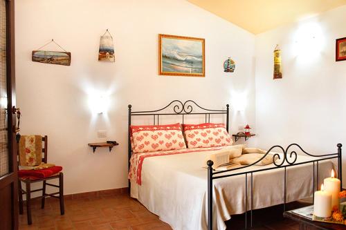 a bedroom with a bed with red pillows at Agriturismo Bocci in Castiglione della Pescaia