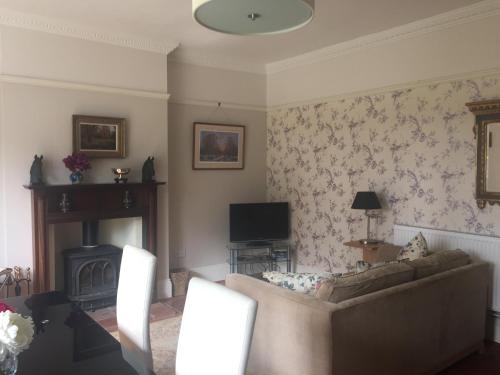 a living room with a couch and a fireplace at The Oaks in Swaffham