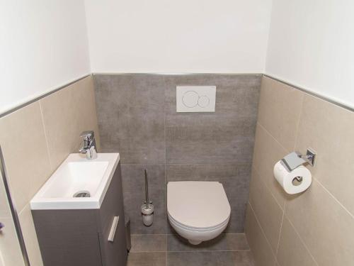 a small bathroom with a toilet and a sink at Gasthof Appartements Gamskar in Bad Gastein