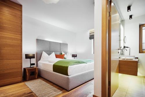 a bedroom with a bed and a bathroom at Mountain Vita in Obertauern