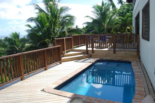 a deck with a swimming pool on top of a house at Moana Villa Aitutaki in Arutanga