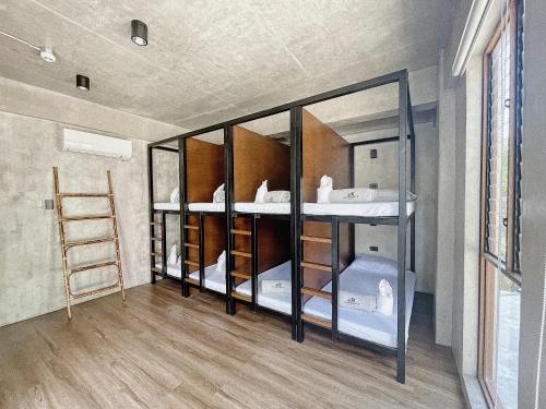 a room with glass shelves in a room at Shorebreak Hostel San Juan La Union in san juan la union