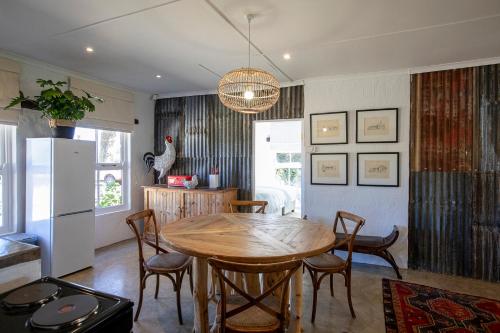 a kitchen and dining room with a wooden table and chairs at Springvale Farm in Nottingham Road