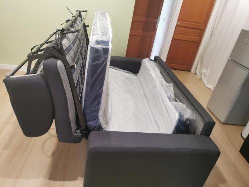 a bed in a room with a mattress at LE CONCORDE-WIFI-Clim-Parking-3étoiles-OcKeys in Bram