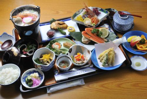 a tray filled with different types of food on a table at Hokkai Hotel in Lake Toya
