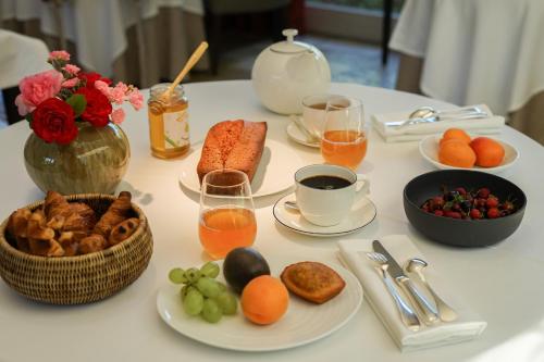 a table with breakfast foods and drinks on it at Hostellerie De Levernois in Levernois