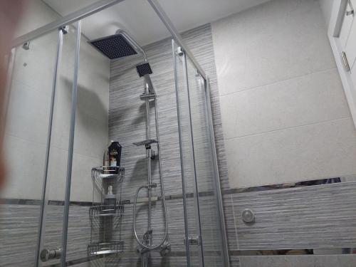 a shower with a glass door in a bathroom at City Lux Apartments in Skopje