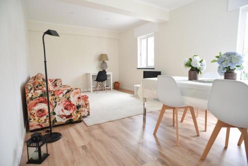 a living room with a table and a chair at Nia Azorean Apartments in Horta