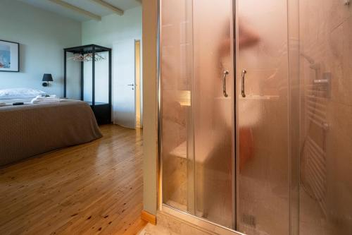 a glass shower in a room with a bed at Tinas Home - Kalamata Mediterranean Villas in Kalamata