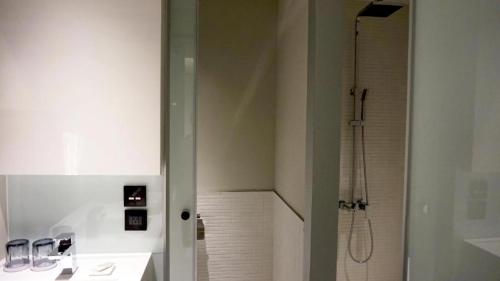 a bathroom with a shower and a sink at Greet Inn in Kaohsiung