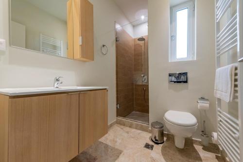 a bathroom with a toilet and a sink and a shower at Tinas Home - Kalamata Mediterranean Villas in Kalamata