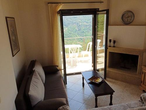 a living room with a couch and a fireplace at Galini Home: Cozy Home with great view of Taygetos 
