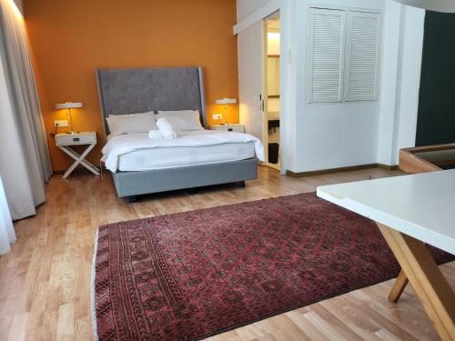 a bedroom with a bed and a red rug at The Boutique Residence Hotel in George Town