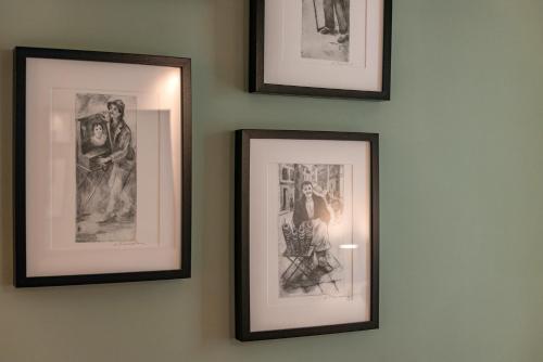 a group of framed pictures hanging on a wall at Tinas Home - Kalamata Mediterranean Villas in Kalamata