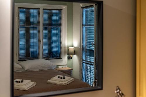 a mirror reflection of a bed in a bedroom at Tinas Home - Kalamata Mediterranean Villas in Kalamata