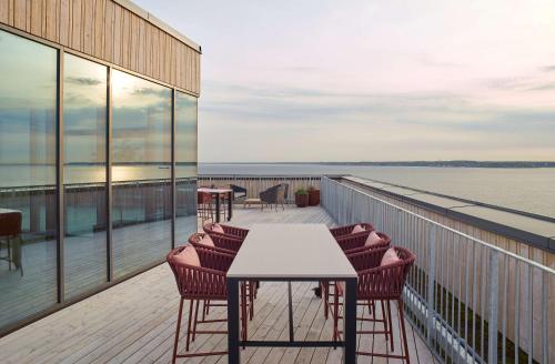 a balcony with chairs and a table on a building at Scandic Oceanhamnen in Helsingborg