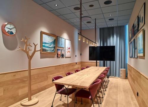 a conference room with a wooden table and chairs at Scandic Oceanhamnen in Helsingborg