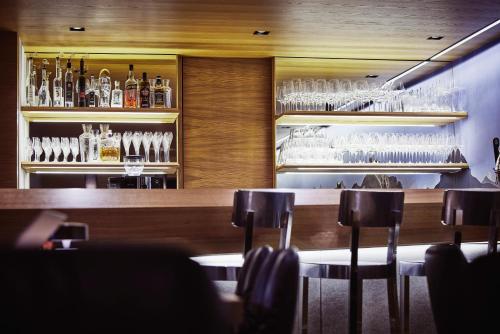 a bar with glasses on the shelves in a restaurant at Mountain Vita in Obertauern