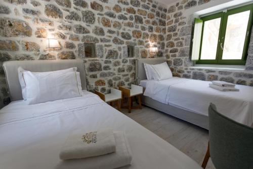 Postel nebo postele na pokoji v ubytování ERMIS-APEA Villas